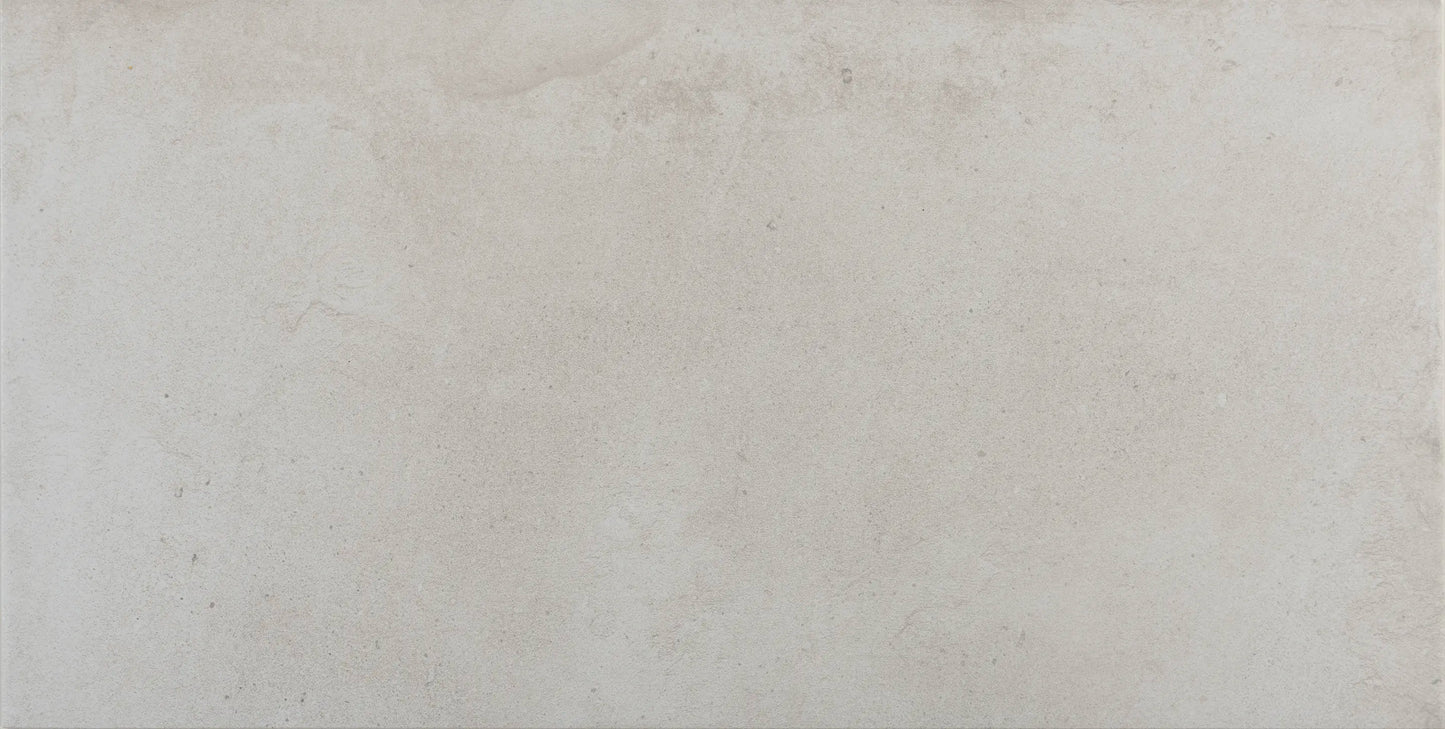 Close-up of matte finish and subtle concrete texture on Proton Blanco tile