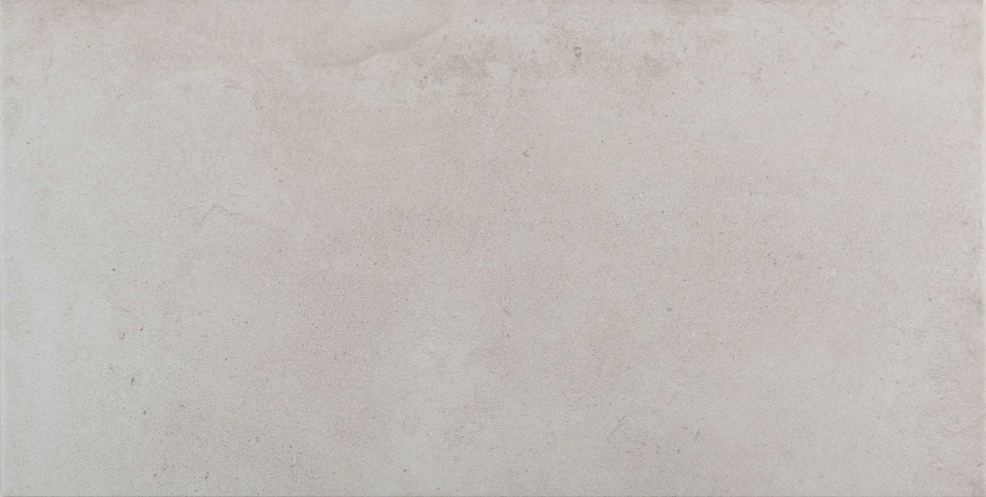 Close-up of matte finish and subtle concrete texture on Proton Blanco tile