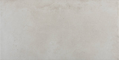 Close-up of matte finish and subtle concrete texture on Proton Blanco tile